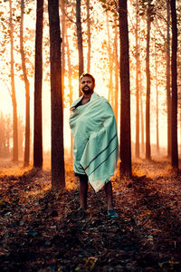Full length of man standing in forest