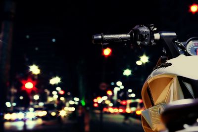 Close-up of illuminated bike on city street at night