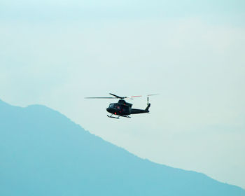 Helicopter in flight. helicopter is flying between mountains peak,vacation tour on helicopter