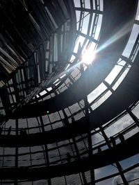 Low angle view of sunlight streaming through ceiling