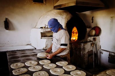 Man working in kitchen at store