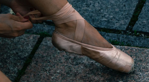 Low section of ballet dancer wearing shoes