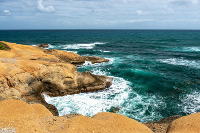 Scenic view of a rocky coast and sea against sky