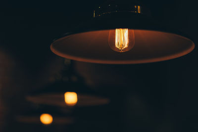 Close-up of illuminated light bulb in darkroom