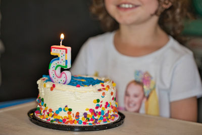 Midsection of woman with chocolate cake