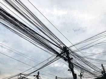 Low angle view of electricity pylon against sky