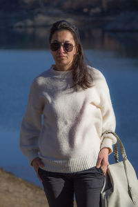 Portrait of woman wearing sunglasses standing outdoors