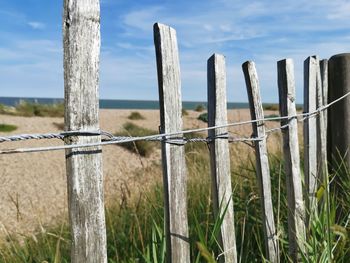 Close-up of barbed wire fence on field