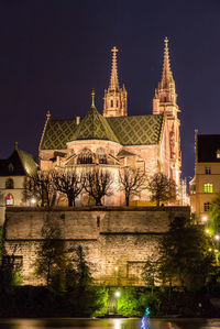 Illuminated building against sky at night