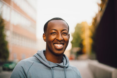 Portrait of smiling young man standing outdoors