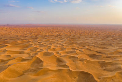 Scenic view of desert against sky during sunset