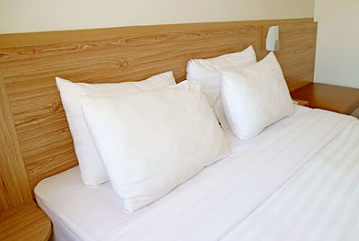 White pillows on the bed for the concept of relaxation