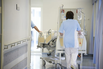 Rear view of woman walking in corridor of building