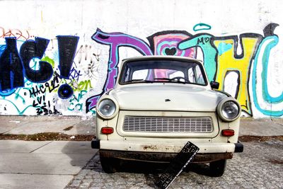 Vintage car on street against wall