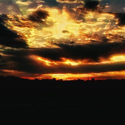 Scenic view of dramatic sky at sunset