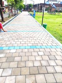 Cobblestone footpath by street in city