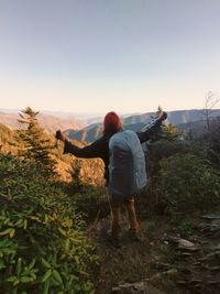 Rear view of man standing on mountain