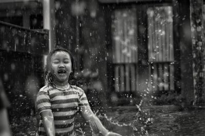 Portrait of boy playing in water