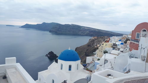 Panoramic view of sea and buildings against sky