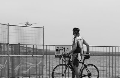 Man riding bicycle against clear sky