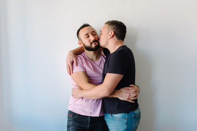 Two gay man hugging each other.