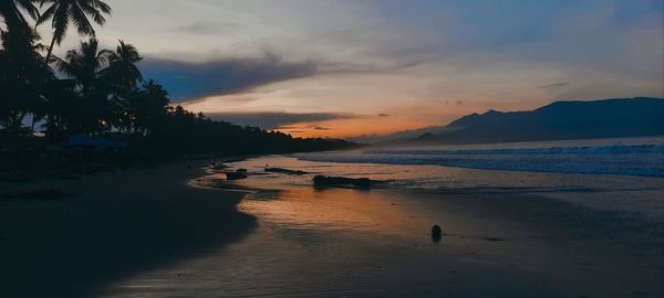 Scenic view of sea against sky at sunset