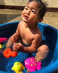 High angle view of girl playing in bathtub