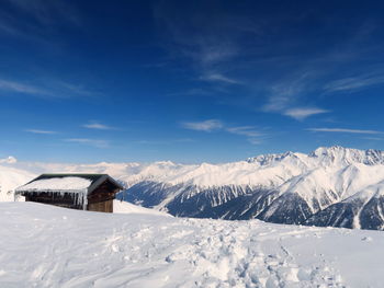 Snowcapped mountains against blue sky