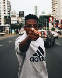 Portrait of young man in city