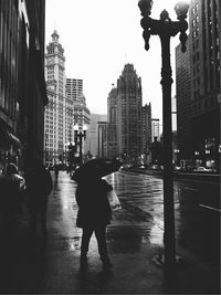 Silhouette of man walking on city street