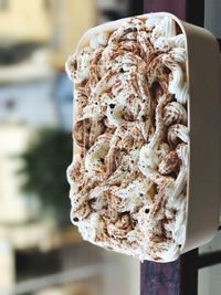 Close-up of dessert in bowl on railing