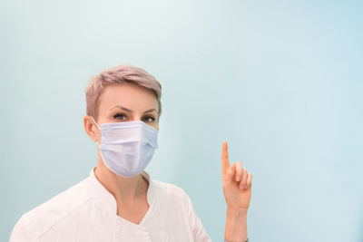 Portrait of man wearing mask against white background