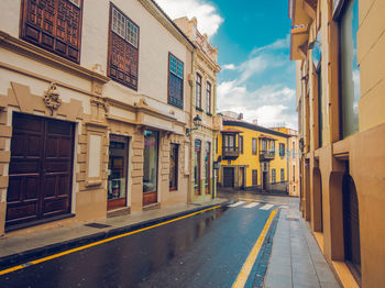 Street amidst buildings in city against sky