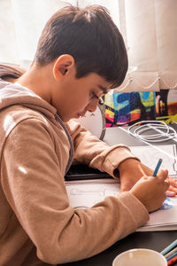 Portrait of boy concentrated drawing