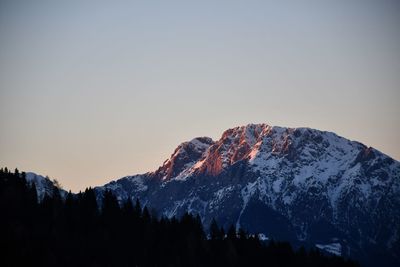 Silhouette mountains against clear sky during winter