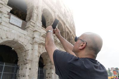 Low angle view of man using mobile phone