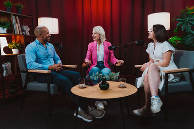 Friends using laptop while sitting at restaurant