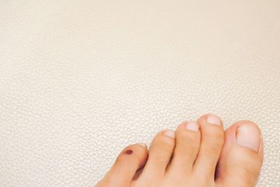 Low section of woman legs against white background