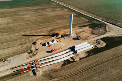 Construction site with windmill turbine parts on ground