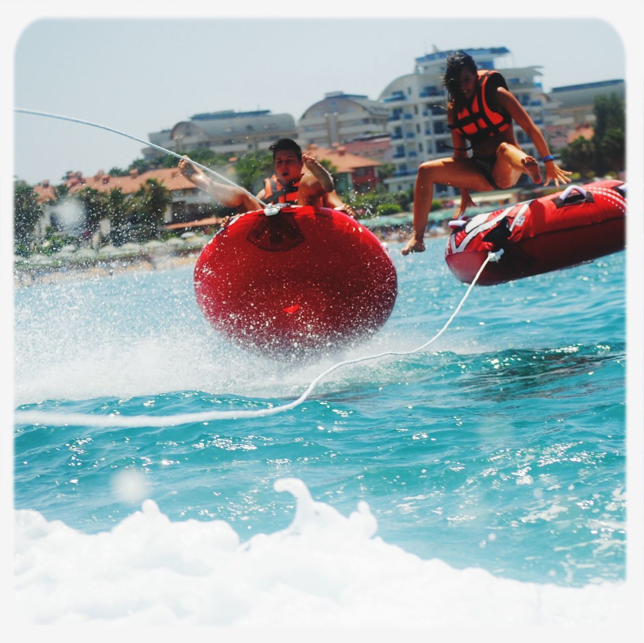 water, transfer print, sea, leisure activity, auto post production filter, lifestyles, childhood, enjoyment, fun, splashing, red, motion, sky, holding, elementary age, girls, playful, outdoors