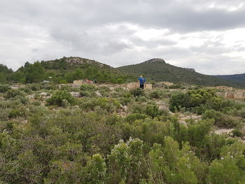 People on mountain against sky