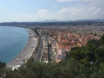 High angle view of townscape by sea against sky