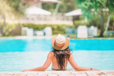 Woman wearing hat in swimming pool