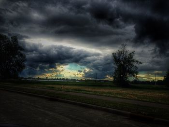 Scenic view of field against cloudy sky