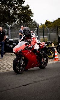 People riding motorcycle on road