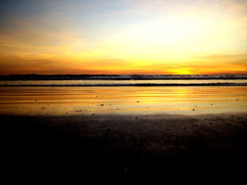 Scenic view of beach against sky during sunset