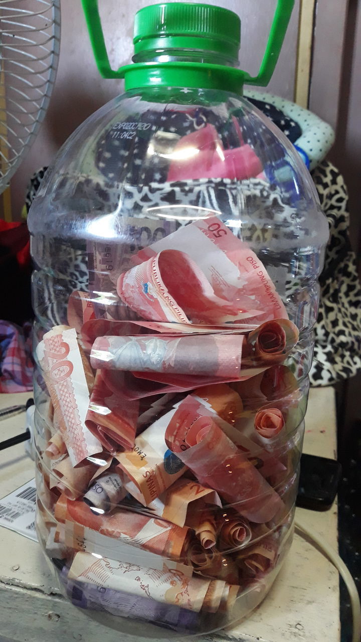 CLOSE-UP OF GLASS JAR ON TABLE