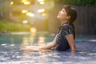 Side view of boy looking away in water