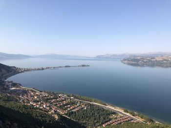 High angle view of sea and cityscape against sky