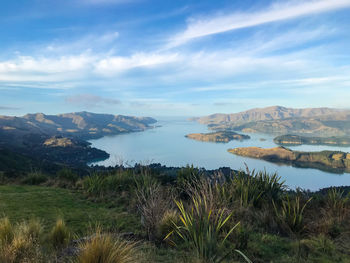 Scenic view of sea and mountains against sky